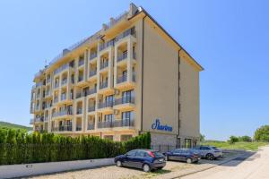 a large building with cars parked in front of it at Azur Properties ap19 in Shkorpilovtsi +24 photos