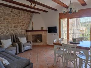 a living room with a table and a couch at Casa Carmeta Beceite in Beceite