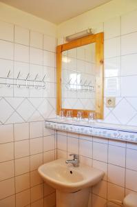 a bathroom with a sink and a mirror at Chata 115 Tatralandia in Liptovský Mikuláš