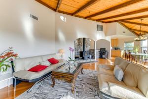 a living room with two couches and a table at Kelseyville Home with Deck and Clear Lake Views! in Kelseyville
