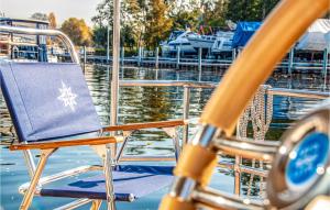 a chair sitting on the deck of a boat at Amazing Ship In Hennigsdorf in Hennigsdorf