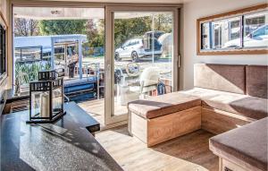 a living room with a couch and a table at Amazing Ship In Hennigsdorf in Hennigsdorf