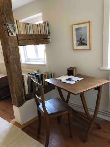 a table and a chair in a room with a bunk bed at Haus am Fluss und See in Gartow