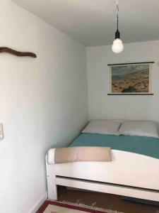 a bedroom with a white bed in a room at Haus am Fluss und See in Gartow