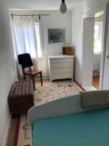 a living room with a couch and a dresser at Haus am Fluss und See in Gartow
