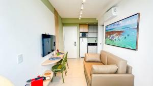 a living room with a couch and a table at Flats no centro de Porto de Galinhas próximo à praia opções com e sem piscina privativa in Porto De Galinhas +66 photos