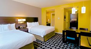 a hotel room with two beds and a desk at TownePlace Suites by Marriott Anchorage Midtown in Anchorage +16 photos
