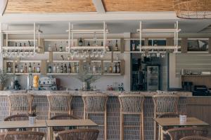 a bar with chairs and tables in a restaurant at Sivota Hotel in Sivota