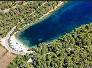 an aerial view of a lake with a road and trees at Apartment Karla in Splitska