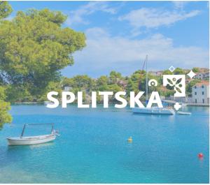 a boat in a body of water with the word spitzka at Apartment Karla in Splitska
