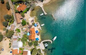 an aerial view of a house and boats in the water at Beautiful Apartment In Punta Kriza in Punta Križa +21 photos