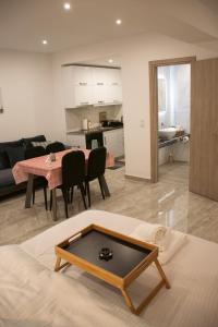 a living room with a table and a dining room at Emily Apartments 3 in Chrysoupolis