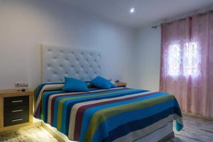 a bedroom with a large bed with blue pillows at Forest Farm in Amman +15 photos
