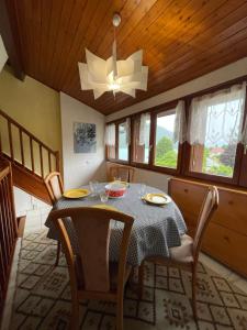 a dining room with a table and chairs and a chandelier at Rare 2 bedroom with private beach on Lake Annecy in Doussard +23 photos