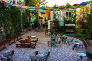 an outdoor patio with tables and chairs and umbrellas at Hotel Terra by Refugio Ecológico in Arequipa