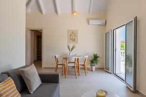 a living room with a couch and a table at White Lotus Loft & Apartments in Laganas