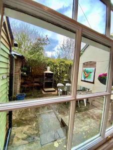 a view of a patio from a window of a house at Carefree Cottage in Marstow