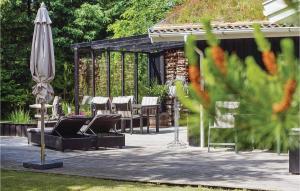 ブロックフスにあるHoliday Home Blokhus With Sauna 156のパティオ(椅子、パラソル、テーブル付)