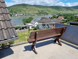 a wooden bench sitting on top of a balcony at Charmante Wohnung in Rheindiebach in Oberdiebach