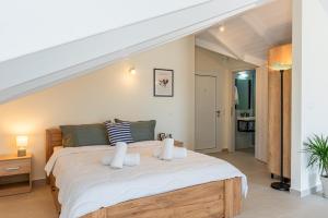 a bedroom with a large bed with two pillows at White Lotus Loft & Apartments in Laganas