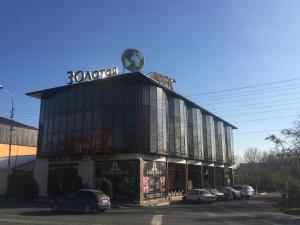 a building with a clock on the top of it at Hotel Zolotoy Globus in Pyatigorsk