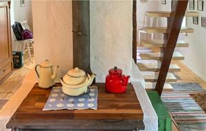 a room with a stove with two tea pots and a staircase at Holiday Home Linghult, Isaka Stuga Eldsberga in Plingshult +7 photos