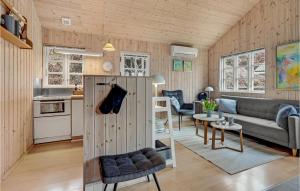 a living room with a couch and a table at Awesome Home In Mariager With Wifi in Mariager
