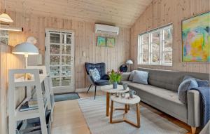 a living room with a couch and a table at Awesome Home In Mariager With Wifi in Mariager