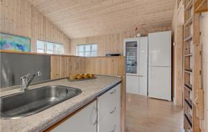 a kitchen with a sink and a refrigerator at Awesome Home In Mariager With Wifi in Mariager