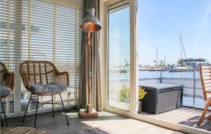 a room with a balcony with a view of the water at D'azur in Aalsmeer