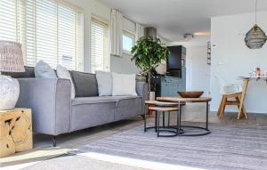 a living room with a couch and a table at D'azur in Aalsmeer