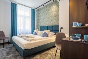 a bedroom with a large bed with a blue headboard at Noclegi Orla 6 in Lublin