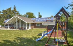 a house with solar panels on the roof at Holiday Home Musestien Dnmk Ii in Marielyst