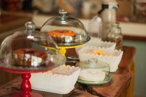 una esposizione di ciambelle in un piatto di vetro su un tavolo di Pousada Passaredo a Brumadinho Altre 9 foto