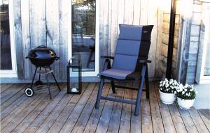 a blue chair sitting on a porch with a grill at Holiday Home Dølemo Hillestadheia Ii in Øvre Ramse