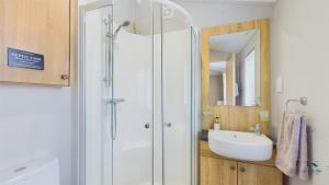 a bathroom with a shower and a sink at Poppy An Immaculate Lake side Lodge the Perfect Retreat, Sleeps 4 in Ryde +23 photos