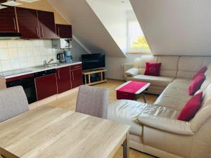 a living room with a couch and a table at Ferienwohnung in Morbach mit Garten und Grill in Morbach