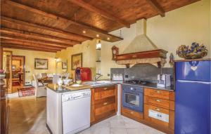a kitchen with a stove and a refrigerator at La Perla in Castiglione Chiavarese +14 photos