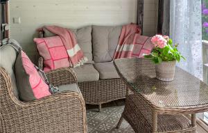a living room with a couch and chairs and a table at Amazing Home In Lidhult With Wifi in Bassarås