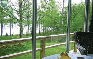 a room with a window with a view of a forest at Amazing Home In Lidhult With Wifi in Bassarås +17 photos