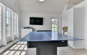 a large blue ping pong table in a room at Four-Bedroom Holiday Home In Bagenkop in Bagenkop