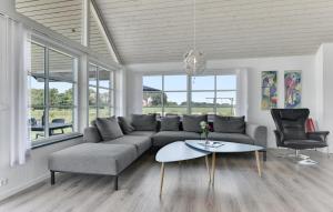 a living room with a couch and a table at Four-Bedroom Holiday Home In Bagenkop in Bagenkop