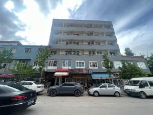 a large building with cars parked in front of it at Hotel Ararat in Doğubayazıt