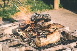 a pile of wood is cooking on a grill at Island Life Cottages in Brackley Beach