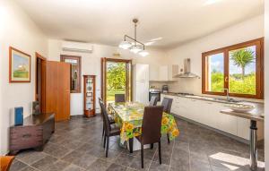 a kitchen and dining room with a table and chairs at Villa Don Pino in Donnalucata