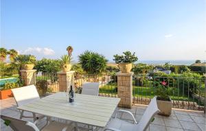 a table and chairs on a patio with a view of the ocean at Villa Don Pino in Donnalucata