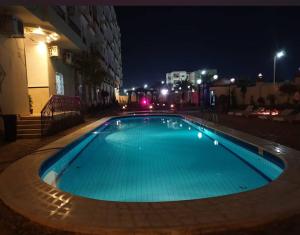 an empty swimming pool at night in a city at Star Pool in Hurghada