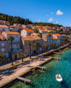 a boat in the water next to a city at Guest House City Center in Korčula +22 photos