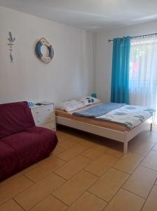 a bedroom with a bed and a couch at Noclegi Relax in Ruciane-Nida