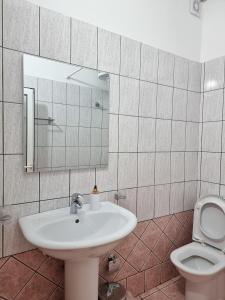a bathroom with a sink and a toilet at Arte Apartment in Sarandë